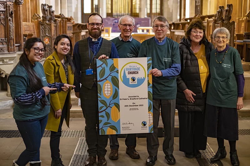 Congregation at St Peter's Bradford Cathedral holding Fairtrade certificate