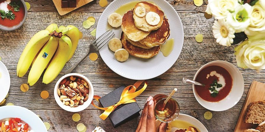 Fairtrade bananas, chocolate and other snacks on a picnic table shot from above