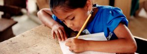 Girl writing at school