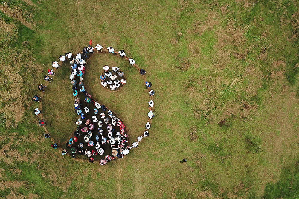 Drone image of people making the Fairtrade mark out of their bodies.