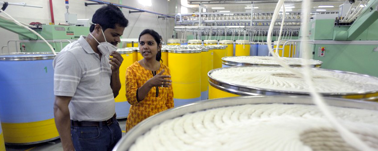 Auditor and woman conducting an audit tour of the cotton factory at Chetna Organic, India