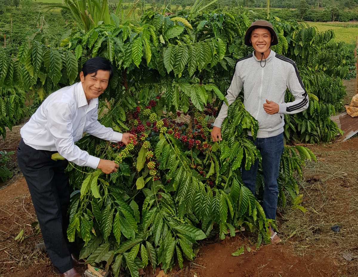 Mr Ha. and his son Vuang Thuan An at their coffee cooperative in Vietnam (by Anna Pierides)