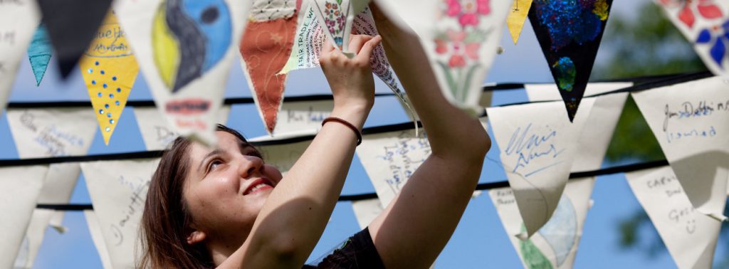 Woman hanging up Fairtrade campaigner flags