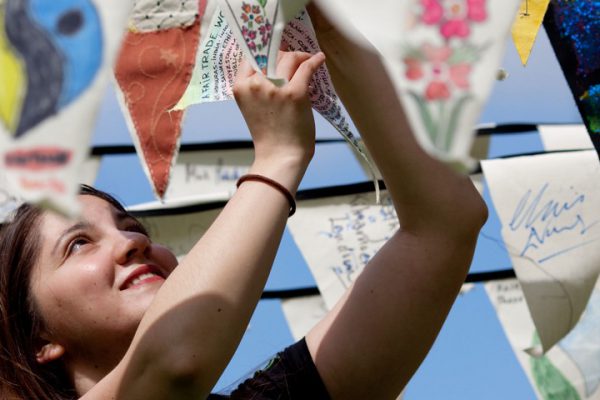 Woman hanging up Fairtrade campaigner flags
