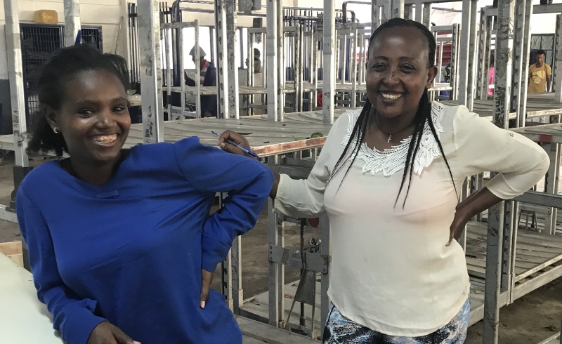 Ayalnesh and Yalfal (two women) smile for the photograph in Herburg Roses building, Ethiopia