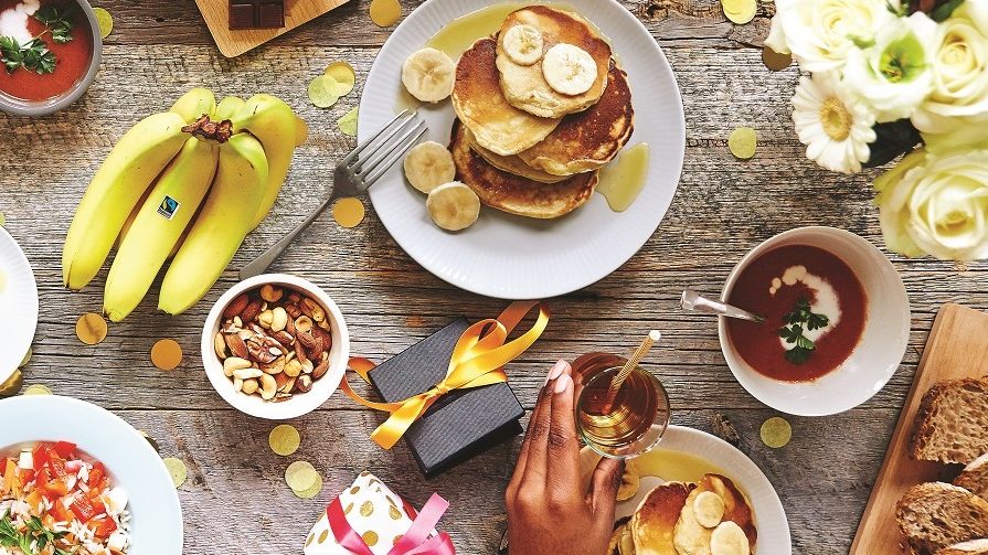 A picnic table shot from above with Fairtrade bananas, pancakes and other goodies