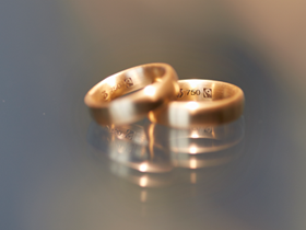 Two Fairtrade gold wedding bands with inscription on the inside