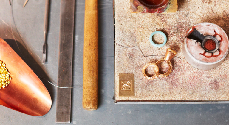 Gold jewellery workshop, tools and materials laid out on a table.