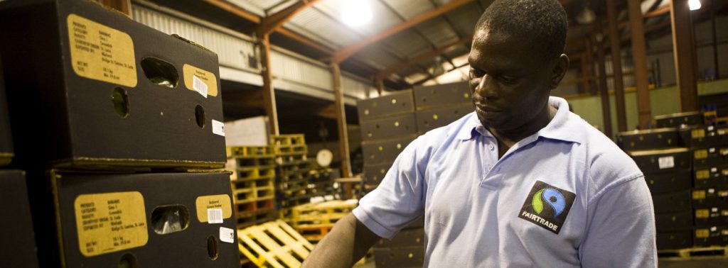 Fairtrade worker with crates of produce