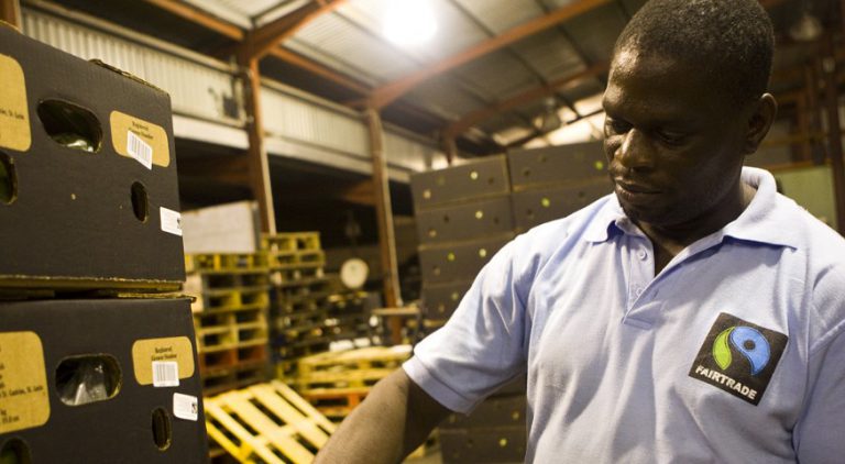 Fairtrade worker with crates of produce