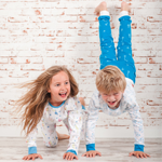 2 children wearing matching Fairtrade cotton pyjamas from Oceanbluu
