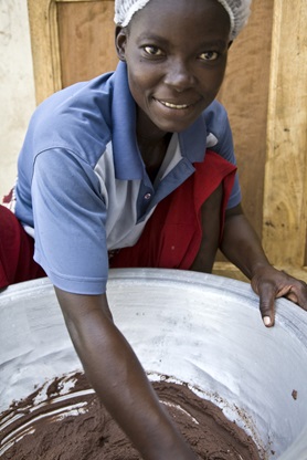 A worker mixing shea