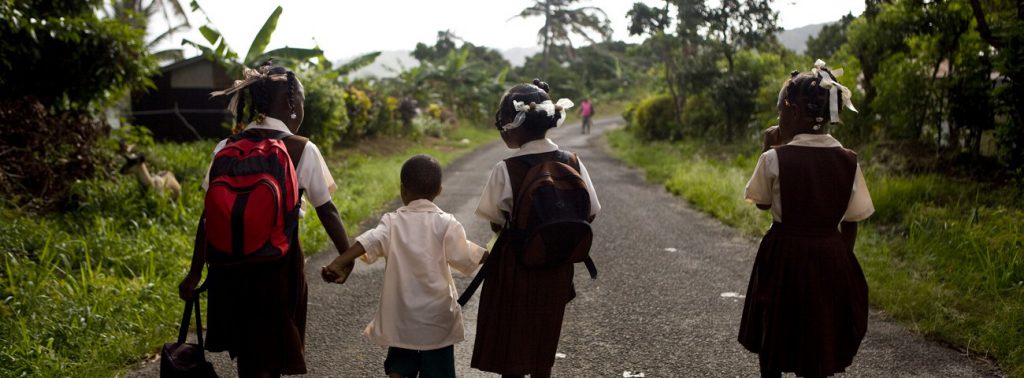 School children walking down a road