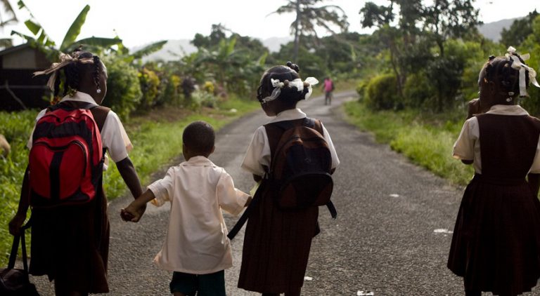 School children walking down a road