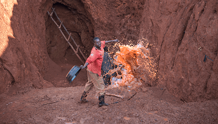 Miners at the Margaret Ikee mine move flood water by hand using their panning basins.