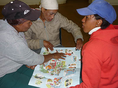 Three people sat together, looking at a diagram