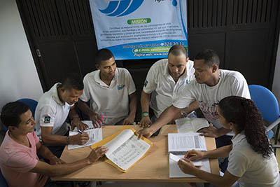 members of a Fairtrade cooperative having a discussion, sat around a table
