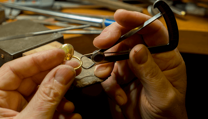 Jeweller holding a Fairtrade gold ring