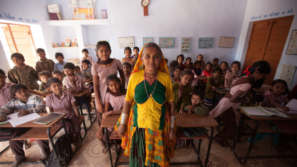 Teacher stands in front of her class at a local school in Rapar district, Gujarat, India.