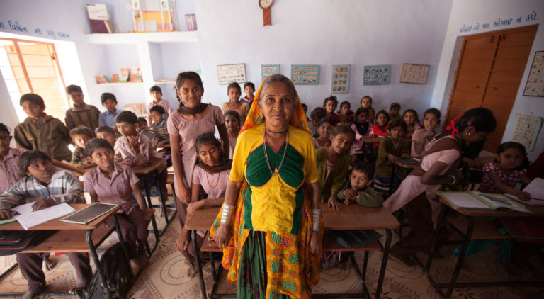 Teacher stands in front of her class at a local school in Rapar district, Gujarat, India.