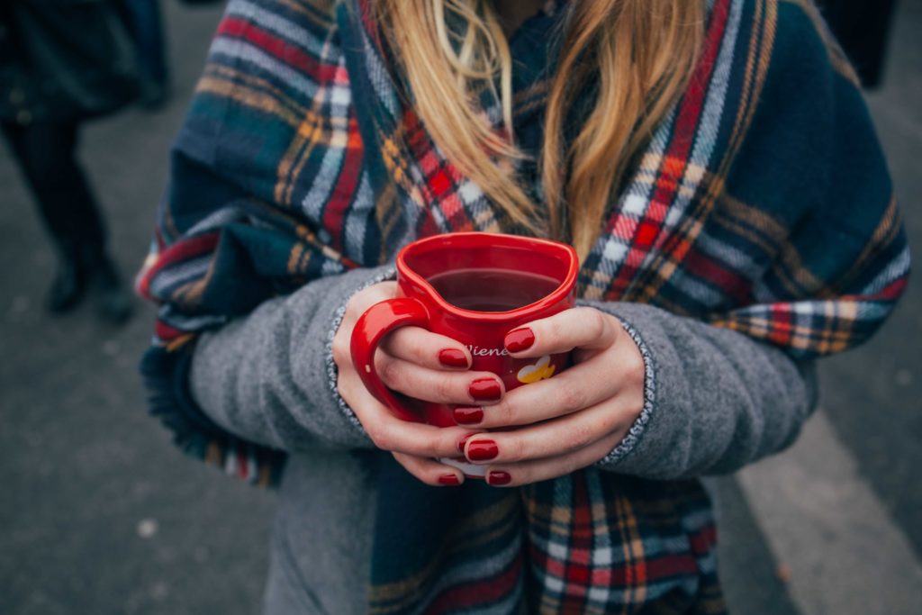 Woman holding a mug of mulled wine