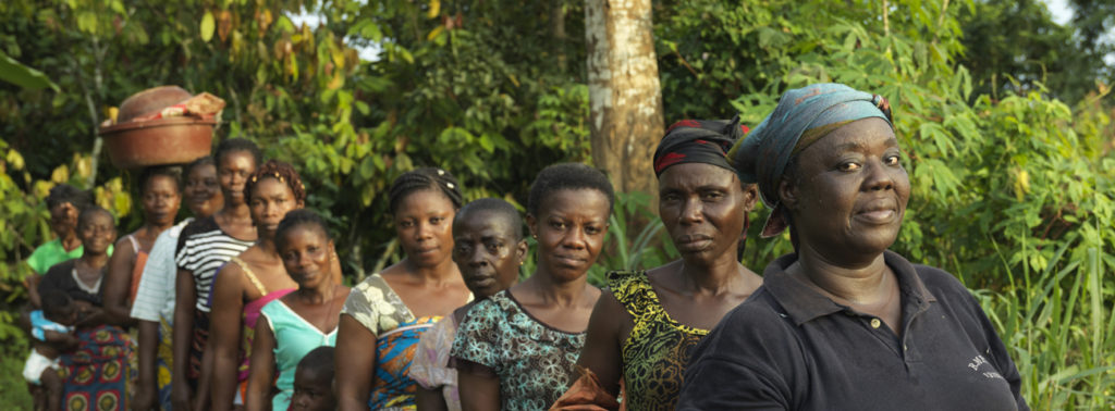 Genevieve, a Fairtrade cocoa farmer in a line of women farmers in Cote d'Ivoire 2018
