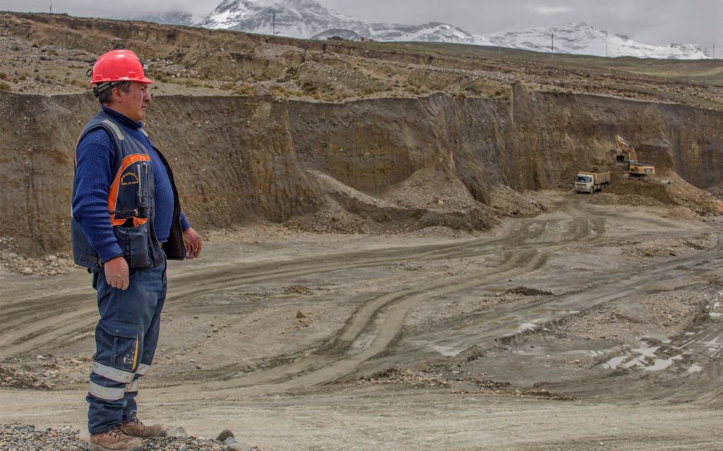 A mine worker stands where gold-rich soil is dug at the mining cooperative Limata