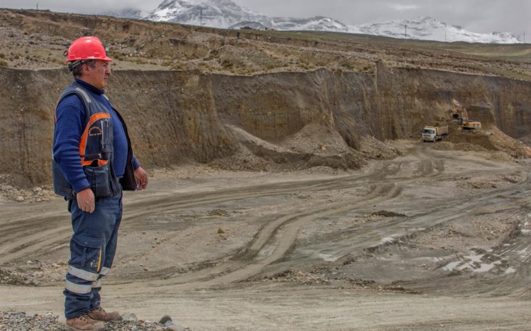 A mine worker stands where gold-rich soil is dug at the mining cooperative Limata