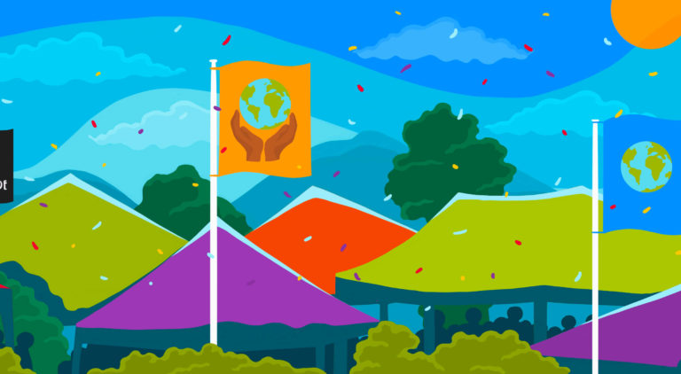 Brightly coloured festival tents among tree tops, with a blue sky. Flags flying above the tents. Flag on the left has the Fairtrade Mark on a black background, middle flag shows a globe held between two hands on orange background, flag on the right shows a globe on a blue background.,
