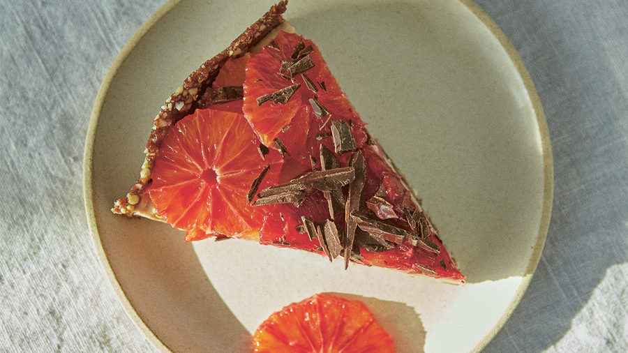 A slice of orange and chocolate freezer cake on a plate shot from above