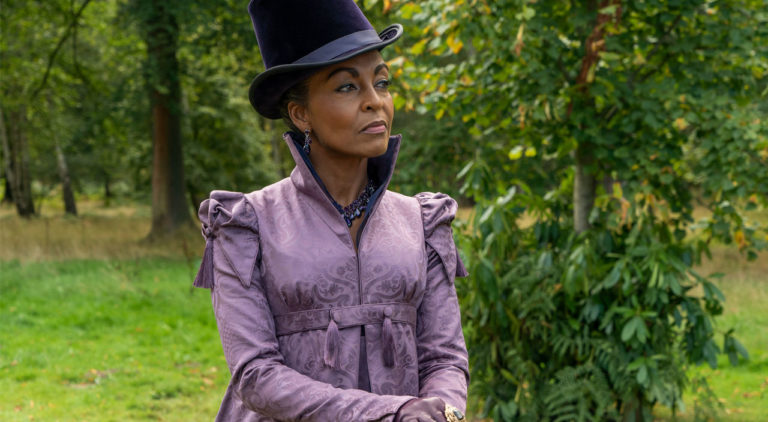 Adjoa Andoh portrait as Lady Danbury, in purple dress and top hat holding a cane