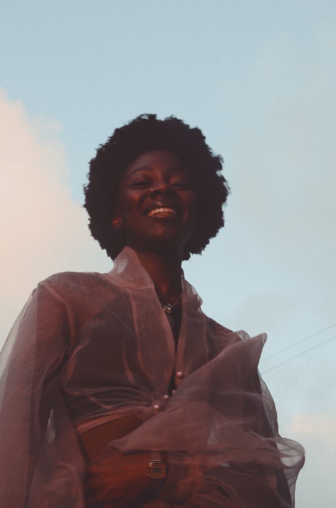 Portrait of Joycelyn Longdon against a blue cloudy sky