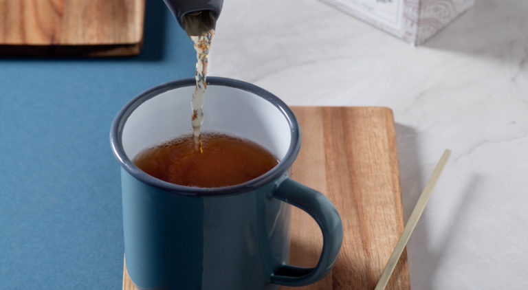 pouring water into a cup of Suki Tea