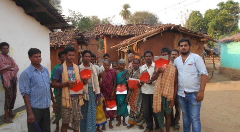 A group of OM Organics farmers and their families standing outside