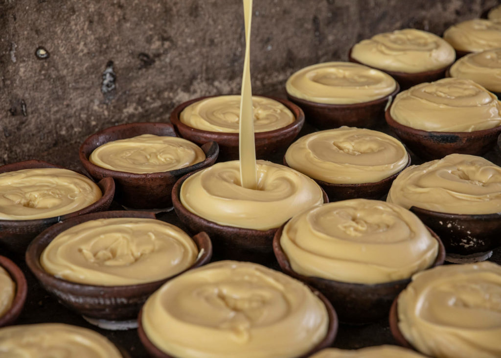 Shea butter being poured into pots