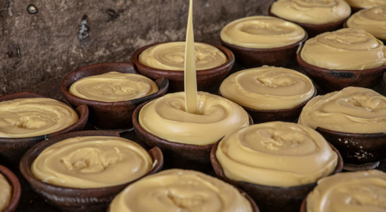 Shea butter being poured into pots