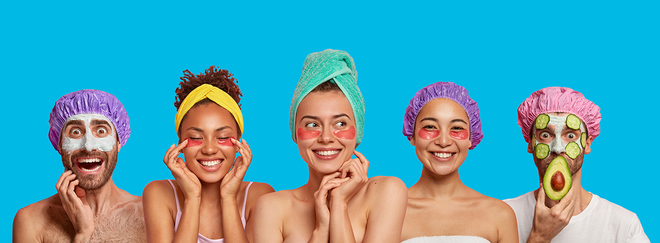 headshot of five male and female faces wearing shower caps and towels with facemasks