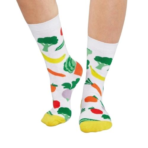 view of lower legs with white cotton socks with various vegetable designs