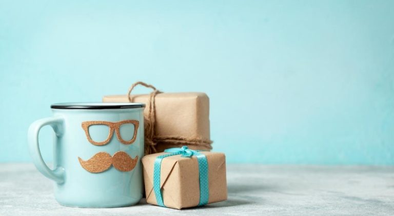 a mug with cutout glasses and moustache and brown paper wrapped presents