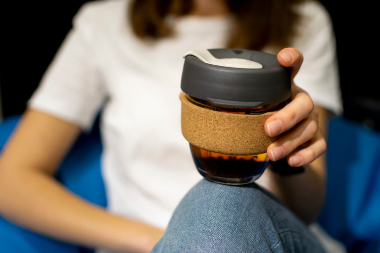 Woman holding Fairtrade coffee cup