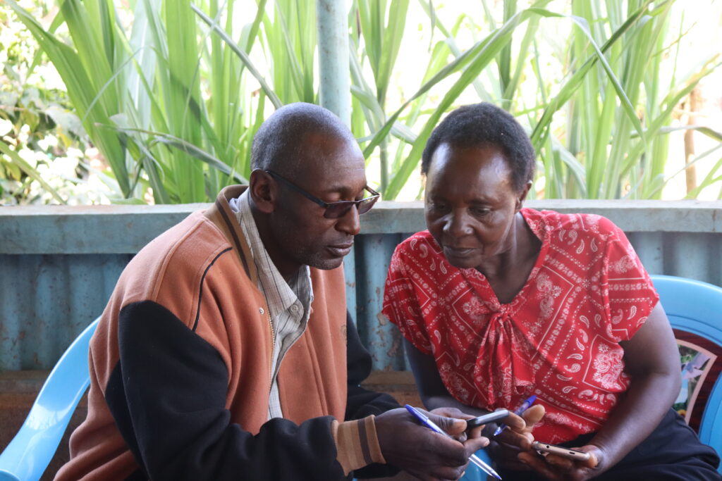 Peter Kariuki Mwaniki & Josyline Wambogo Njagi, two of the community researchers, practice interviewing techniques as part of their training for FairVoice.